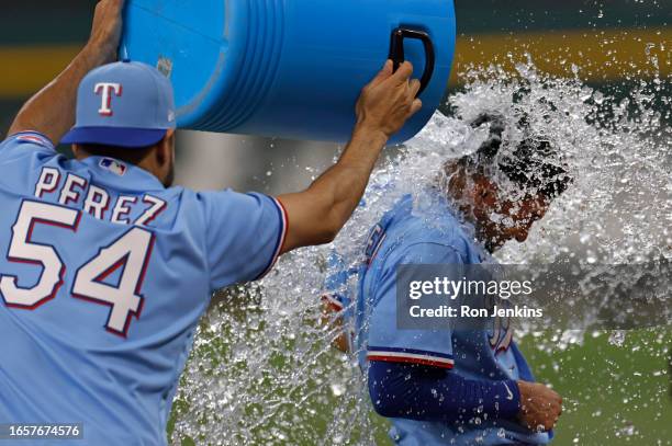 Marcus Semien of the Texas Rangers is doused with ice water by teammate Martin Perez following the team's 9-4 win over the Oakland Athletics at Globe...