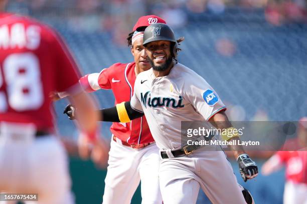 Abrams of the Washington Nationals tags out Bryan De La Cruz of the Miami Marlins trying to stretch a single in the ninth inning during a baseball...