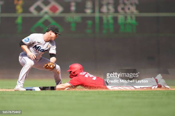 Jacob Young of the Washington Nationals beats the tag by Joey Wendle of the Miami Marlins to steal second base in the fifth inning during a baseball...