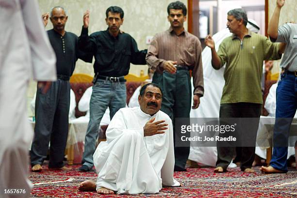 Shiahs Muslims mourn during day one of a three-day institution of aza-e-Hussain November 23, 2002 in Manama, Bahrain. The mourners raise their hand...