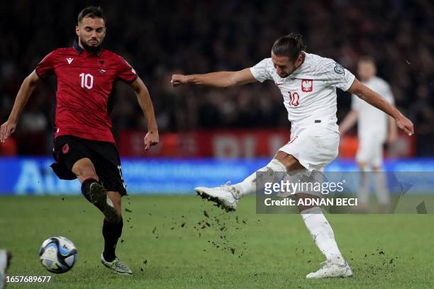Poland's midfielder Grzegorz Krychowiak kicks the ball in front of Albania's midfielder Myrto Uzuni during the UEFA Euro 2024 Group E qualification...