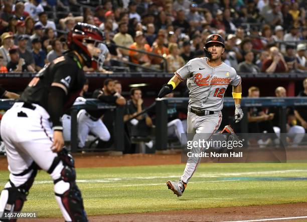 Adam Frazier of the Baltimore Orioles scores on a single by Gunnar Henderson against the Arizona Diamondbacks during the second inning at Chase Field...