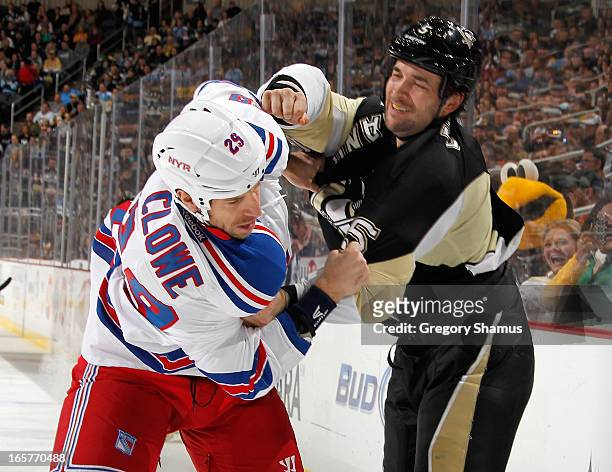 Deryk Engelland of the Pittsburgh Penguins delivers a punch on Ryane Clowe of the New York Rangers on April 5, 2013 at Consol Energy Center in...