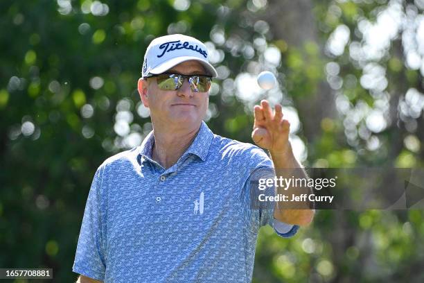 Steve Flesch tosses his golf ball in the air before hitting his first shot on the 11th hole during the third round of the Ascension Charity Classic...