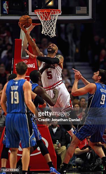 Carlos Boozer of the Chicago Bulls puts up a shot against the Orlando Magic at the United Center on April 5, 2013 in Chicago, Illinois. NOTE TO USER:...