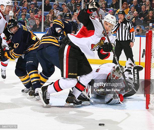 Mike Lundin and Robin Lehner of the Ottawa Senators look to clear the puck as Steve Ott and Nathan Gerbe of the Buffalo Sabres keep a close eye on...