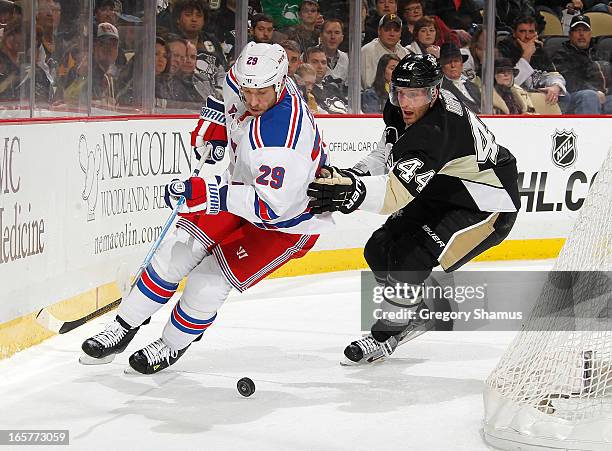 Ryane Clowe of the New York Rangers moves the puck in front of Brooks Orpik of the Pittsburgh Penguins on April 5, 2013 at Consol Energy Center in...