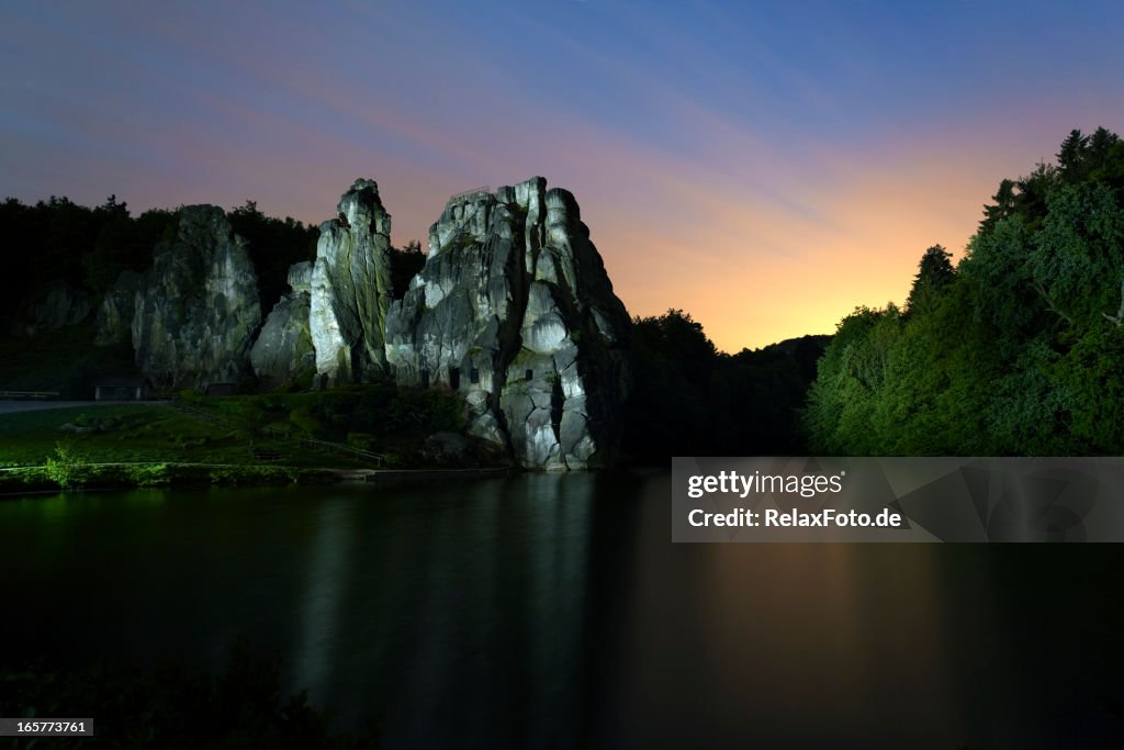 Illuminated rock at dusk - Externsteine in North Rhine Westfalia