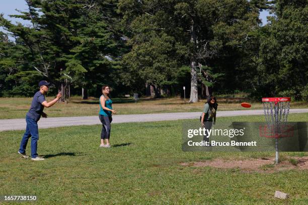 Visitors engage in a match of Disc Golf at Heckscher State Park on September 03, 2023 in East Islip, New York. The weekend marks the traditional end...
