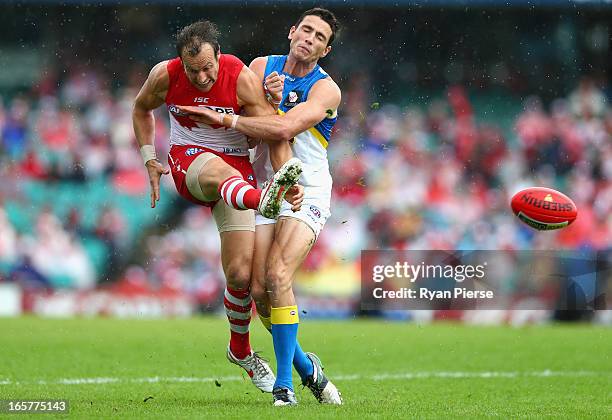 Jude Bolton of the Swans gets a kick away despite pressure from Tom Murphy of the Suns during the round two AFL match between the Sydney Swans and...