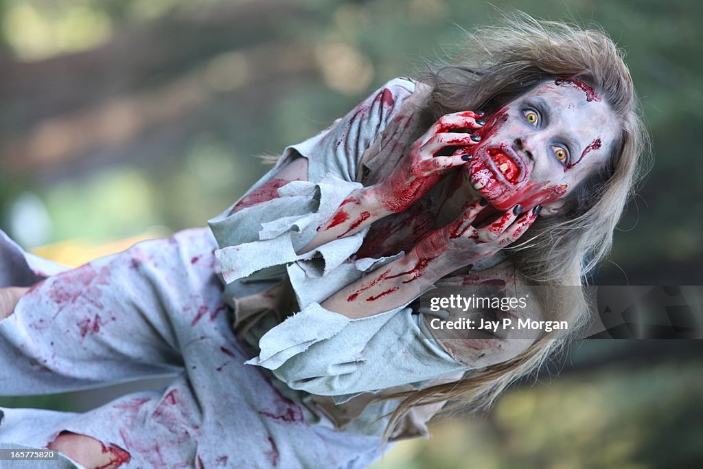 Zombie woman scratches her face