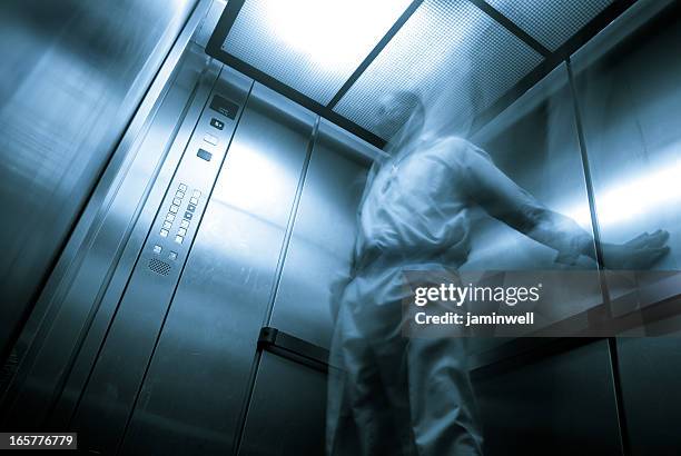 elevator claustrophobia; ghostly apparition in enclosed space - phobia stock pictures, royalty-free photos & images
