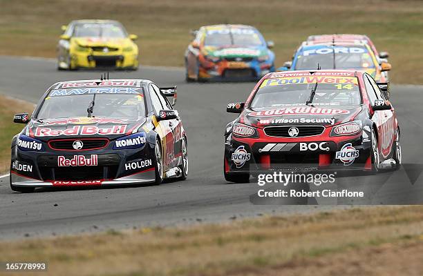 Jamie Whincup driver of the Red Bull Racing Australia Holden is overtaken by Fabian Coulthard driving the Lockwood Racing Holden during race three...