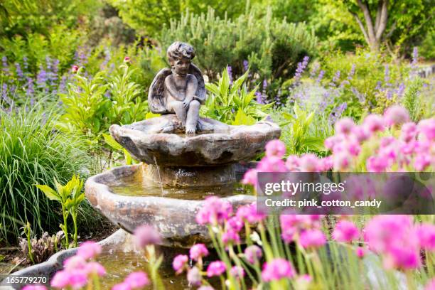 angel statue fountain in garden - water fountain stock pictures, royalty-free photos & images