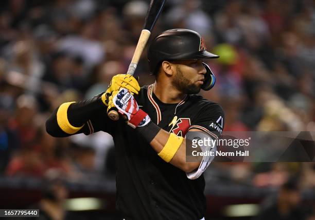 Lourdes Gurriel Jr of the Arizona Diamondbacks wears yellow wrist bands and a yellow ribbon on his jersey in honor of Childhood Cancer Awareness...