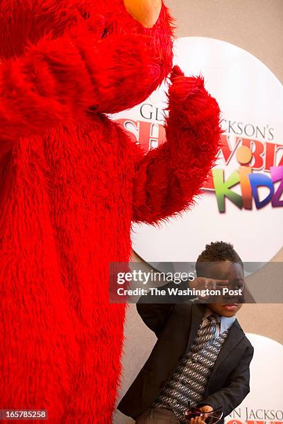 Sesame Street's Elmo takes a photo with Darius Yarborough, 4 during the 3rd Annual Glynn Jackson's Show Biz Kidz at The Silver Spring Civic Building...