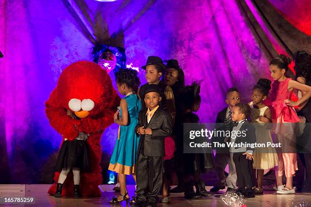 Sesame Street's Elmo surprises the children on stage during in the 3rd Annual Glynn Jackson's Show Biz Kidz at The Silver Spring Civic Building in...