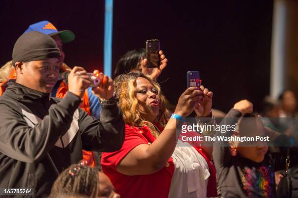 Kim Walker takes pictures of her daughter Kymberly Walker who is on the runway in the 3rd Annual Glynn Jackson's Show Biz Kidz at The Silver Spring...