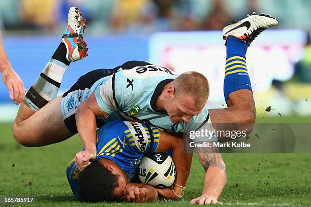 Luke Lewis of the Sharks tackles Kelepi Tanginoa of the Eels during the round five NRL match between the Parramatta Eels and the Cronulla Sharks at...