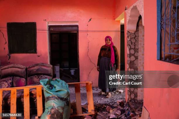 Woman stands inside her heavily damaged home on September 10, 2023 in Moulay Brahim, Morocco. An earthquake measuring 6.8 on the Richter scale hit...