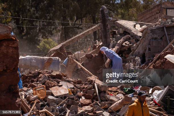 Woman looks into the rubble of a collapsed building on September 10, 2023 in Moulay Brahim, Morocco. An earthquake measuring 6.8 on the Richter scale...