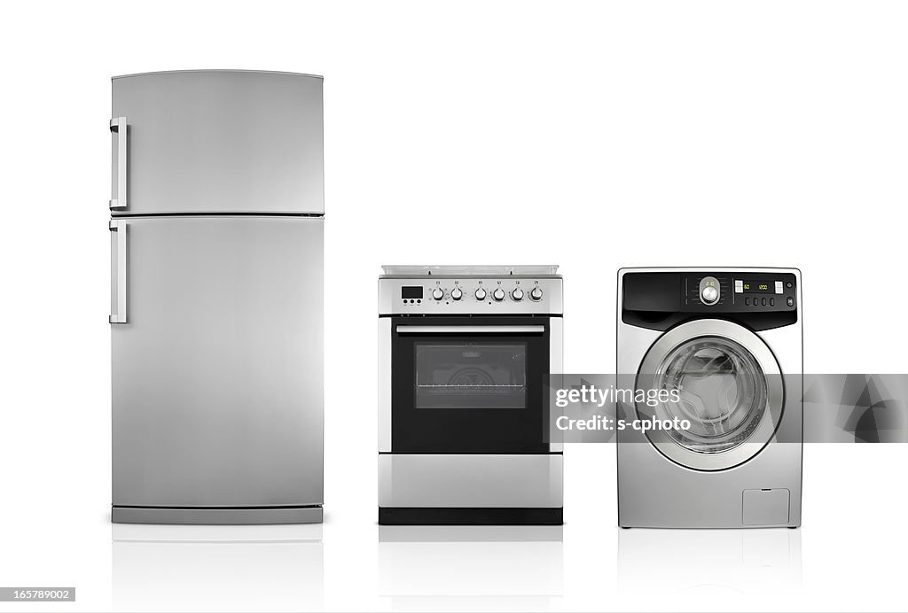A silver fridge, an oven and dryer lined up side by side