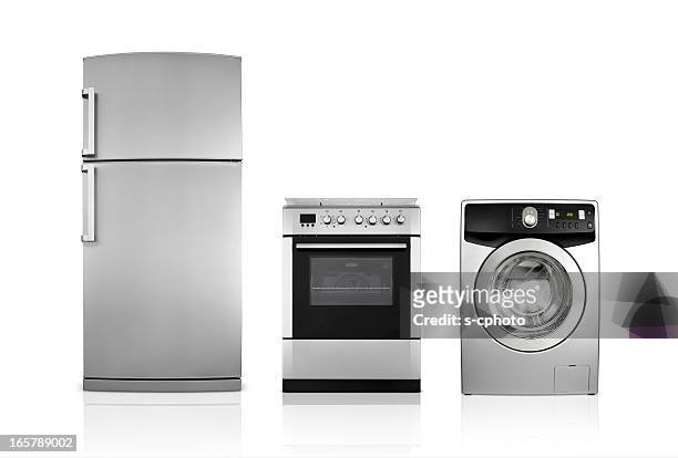 a silver fridge, an oven and dryer lined up side by side - rostfritt stål bildbanksfoton och bilder