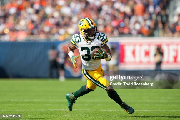 Running Back Aaron Jones of the Green Bay Packers runs the ball during an NFL football game against the Chicago Bears at Soldier Field on September...