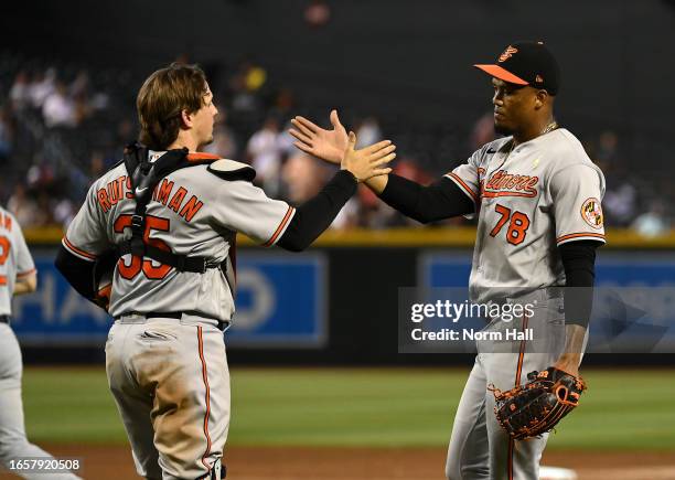 Yennier Cano and Adley Rutschman of the Baltimore Orioles celebrate an 8-5 win against the Arizona Diamondbacks at Chase Field on September 03, 2023...