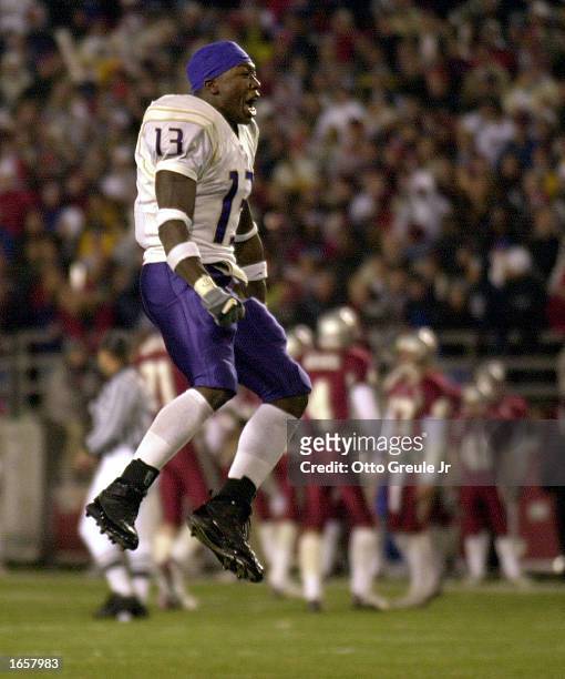 Nate Robinson of the Washington Huskies jumps for joy after defeating the Washington State Cougars 29-26 in triple overtime on November 23, 2002 at...