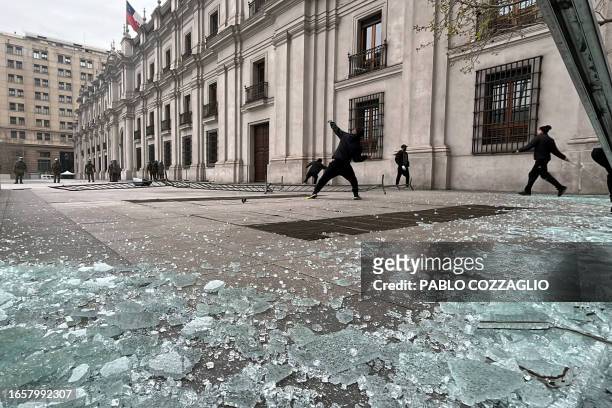 Demonstrators clash with riot police outside La Moneda Presidential Palace in Santiago on September 10 during a protest to commemorate the 50th...