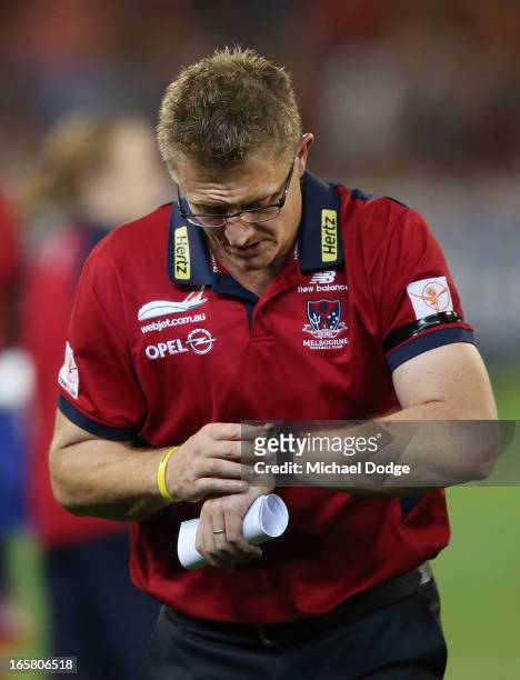 Demons coach Mark Neeld looks at his watch at three quarter time during the round two AFL match between the Essendon Bombers and the Melbourne Demons...