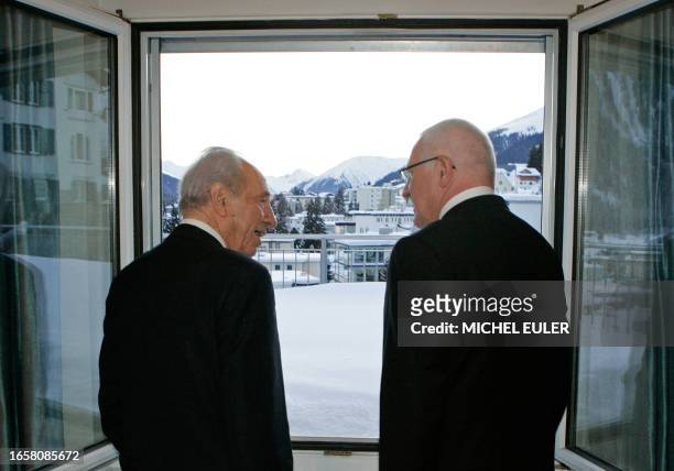 Czech Republic's President Vaclav Klaus and Israel's President Shimon Peres look out the window of a hotel in Davos, Switzerland, January 31, 2009....