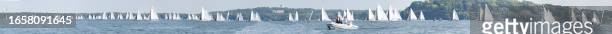 In a composite image, more than 100 boats attempt to start over a mile long line during the E Scow Nationals Regatta on September 10 on Lake Mendota...