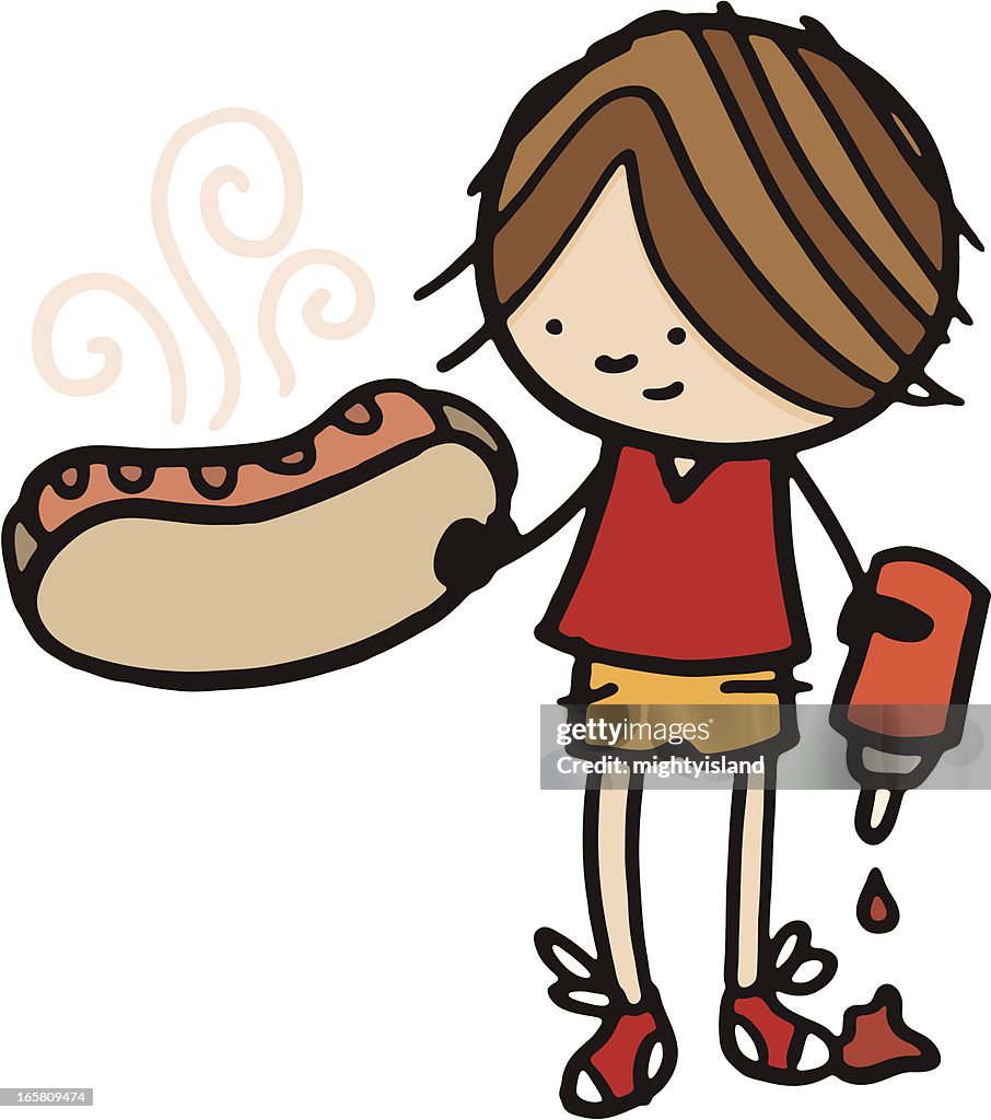 Little boy holding a large hot dog and ketchup