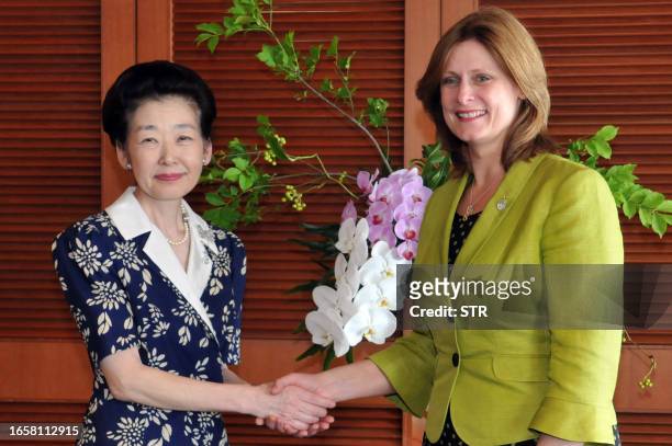Japan's Prime Minister Yasuo Fukuda's wife Kiyoko Fukuda shakes hands with Sarah Brown, wife of British Prime Minister Gordon Brown following a...