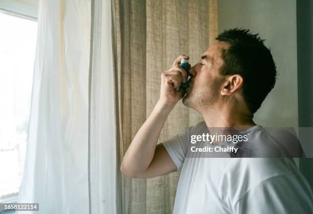 living with asthma - inhaler stock pictures, royalty-free photos & images