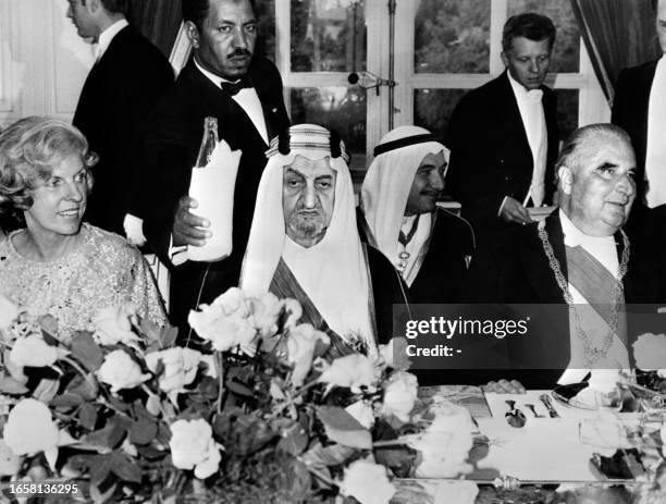 Saudi Arabia's King Faisal ibn Abdul Aziz Al Saud attends on May 14 a official diner at Paris Elysee Palace, surrounded by French President Georges...