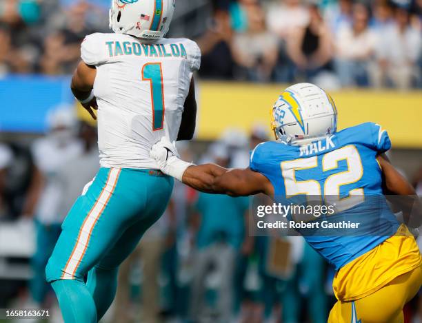 Inglewood, CA, Sunday, Sept. 10, 2023 - Miami Dolphins quarterback Tua Tagovailoa escapes the grasp of Los Angeles Chargers linebacker Khalil Mack...