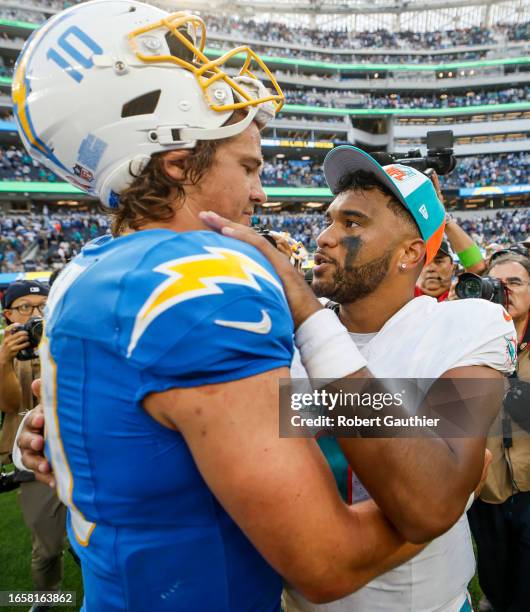 Inglewood, CA, Sunday, Sept. 10, 2023 - Chargers quarterback Justin Herbert and Dolphins quarterback Tua Tagovailoa embrace after the game at SoFi...