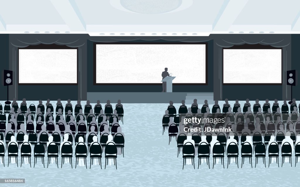Large conference room with speaker and three screens