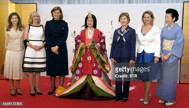 Japanese woman dressed in an ancient kimono poses with from L-R: Margarida Sousa Uva, wife of EU Commission Chairman Jose Manuel Barroso, Laureen...