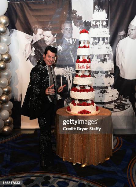 Elvis impersonator Brian Mills poses with a six-tiered cake chef Christina Nasso made that was inspired by Elvis and Priscilla Presley's 1967 wedding...
