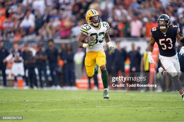 Running Back Aaron Jones of the Green Bay Packers runs the ball during an NFL football game against the Chicago Bears at Soldier Field on September...