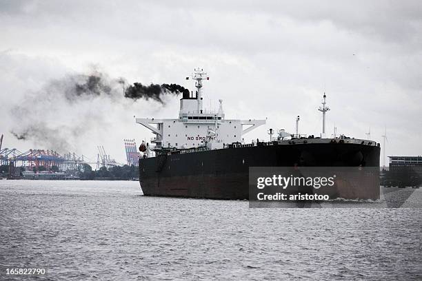 dark oil tanker ship with smoke trail - ship fumes stock pictures, royalty-free photos & images