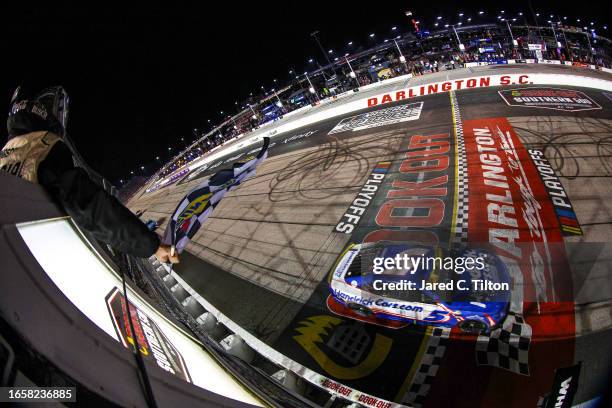 Kyle Larson, driver of the HendrickCars.com Chevrolet, takes the checkered flag to win the NASCAR Cup Series Cook Out Southern 500 at Darlington...