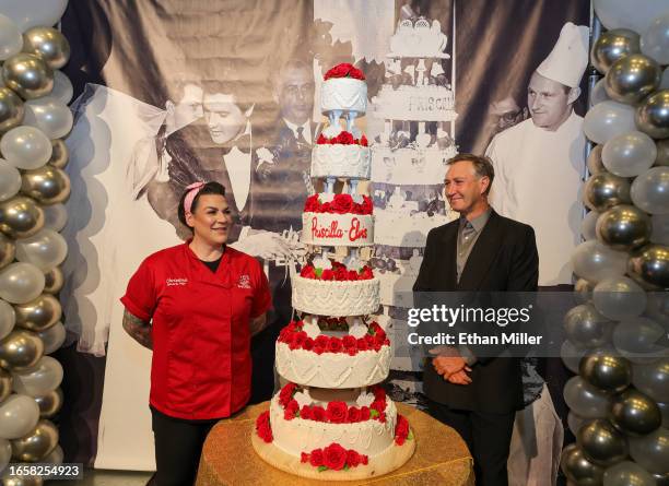 General manager of Carlo's Bakery Christina Nasso and Jag Jaeger pose with a six-tiered cake Nasso made that was inspired by Elvis and Priscilla...