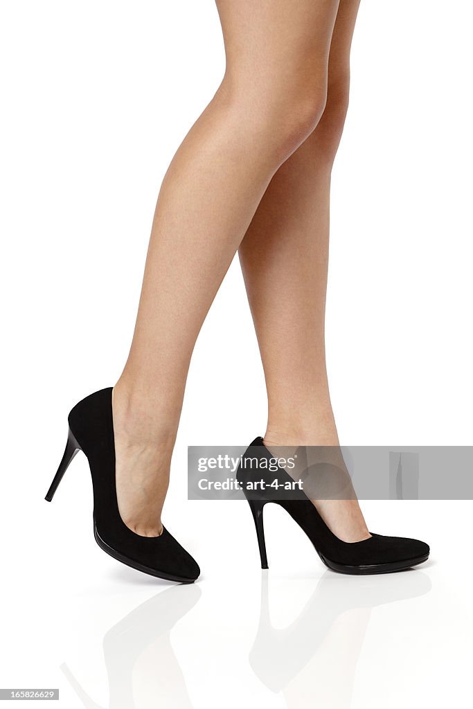 Woman's legs in black high heels