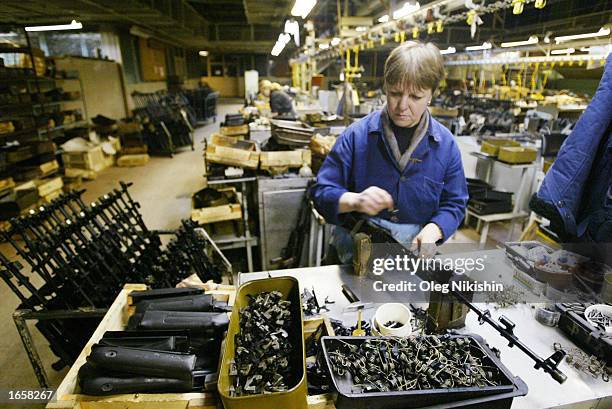 Workers makes an AK-47 on the conveyor line at the gun plant November 23, 2002 in Izhevsk,1000 East km. From Moscow. November 23 marked the 55th...