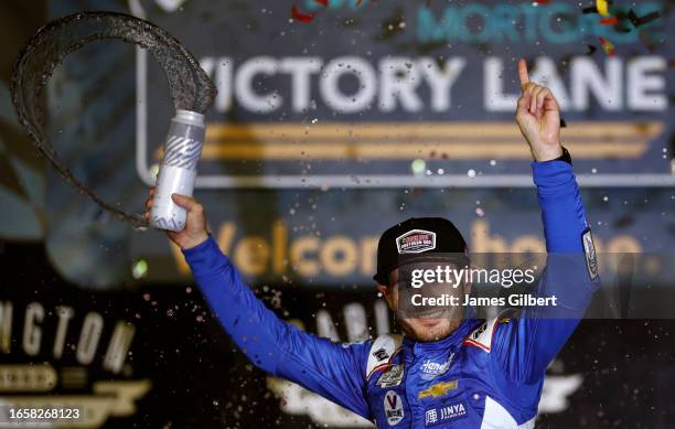 Kyle Larson, driver of the HendrickCars.com Chevrolet, celebrates in victory lane after winning the NASCAR Cup Series Cook Out Southern 500 at...